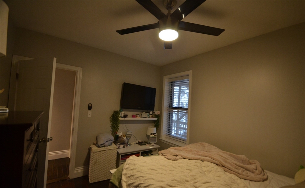 60 Florida Street, Unit 2 Boston, MA 02124 - Photo 16 of 25 a bedroom with a bed and a flat screen tv