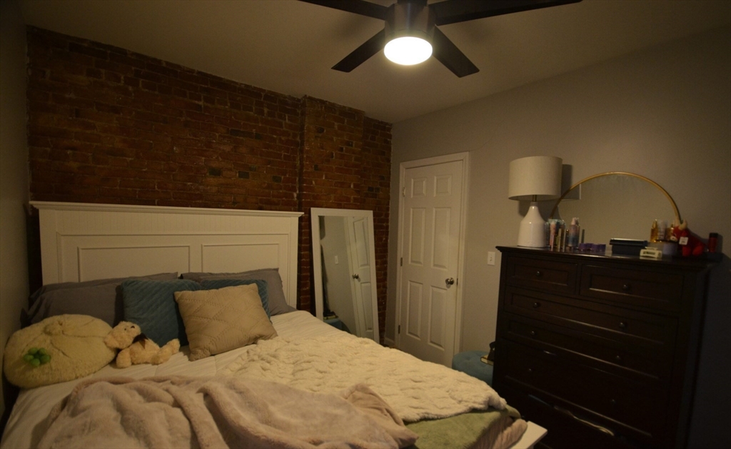 60 Florida Street, Unit 2 Boston, MA 02124 - Photo 17 of 25 a bedroom with a bed and a dresser