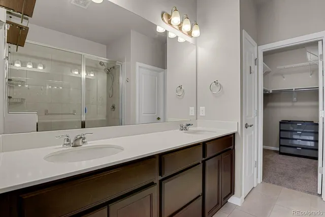 a bathroom with a sink double vanity and a mirror