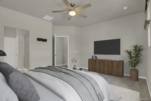 a bedroom with a bed and a television