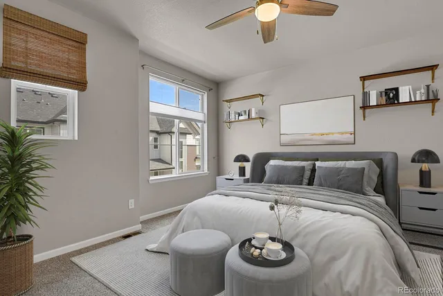 a bedroom with bed and a potted plant