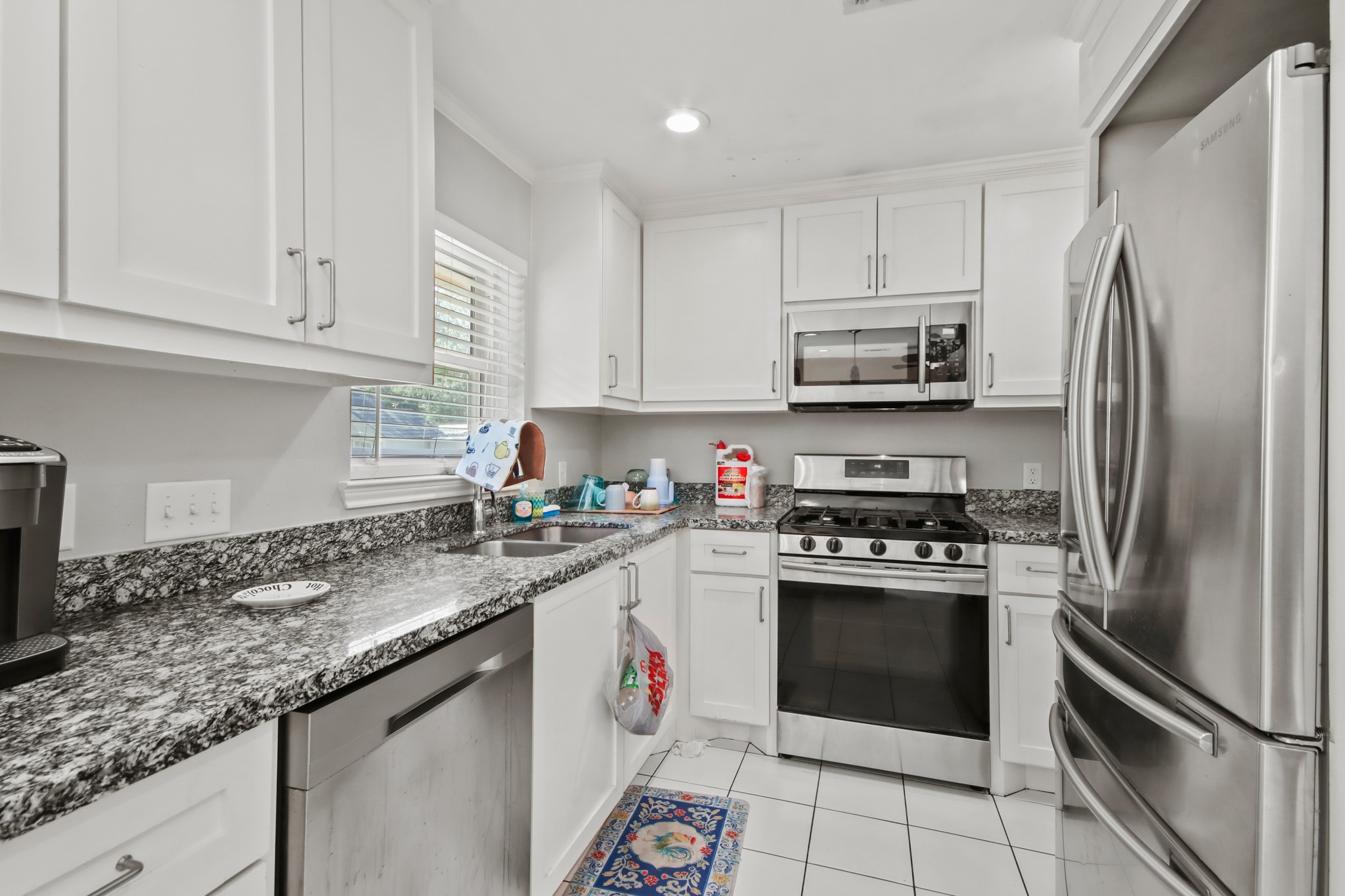 5302 Treaschwig Road Spring, TX 77373 - Photo 15 of 50 a kitchen with granite countertop a stainless steel appliances cabinets a sink and a counter top space