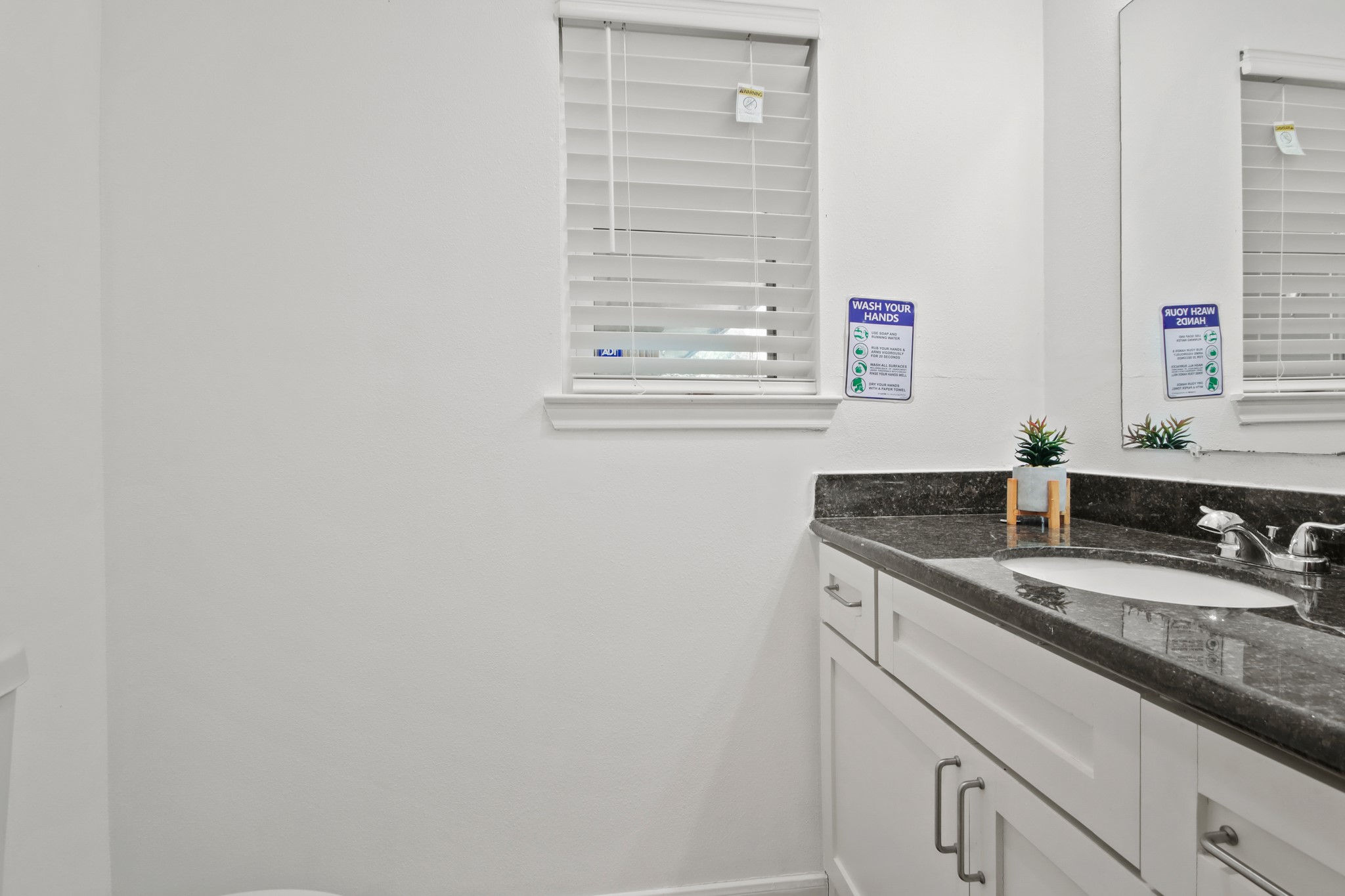 5302 Treaschwig Road Spring, TX 77373 - Photo 24 of 50 a bathroom with a granite countertop sink and a mirror