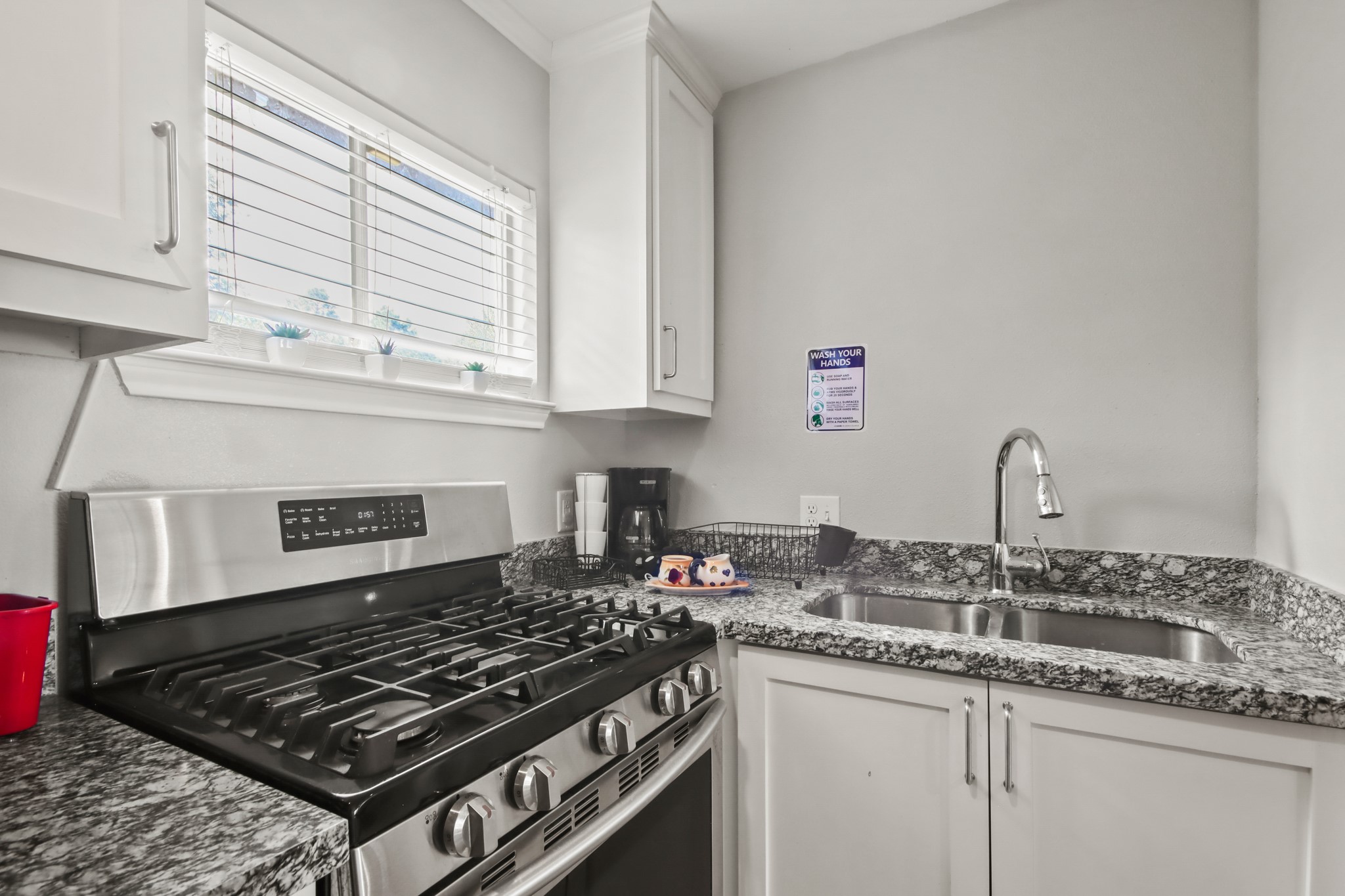 5302 Treaschwig Road Spring, TX 77373 - Photo 31 of 50 a kitchen with granite countertop a stove and a sink