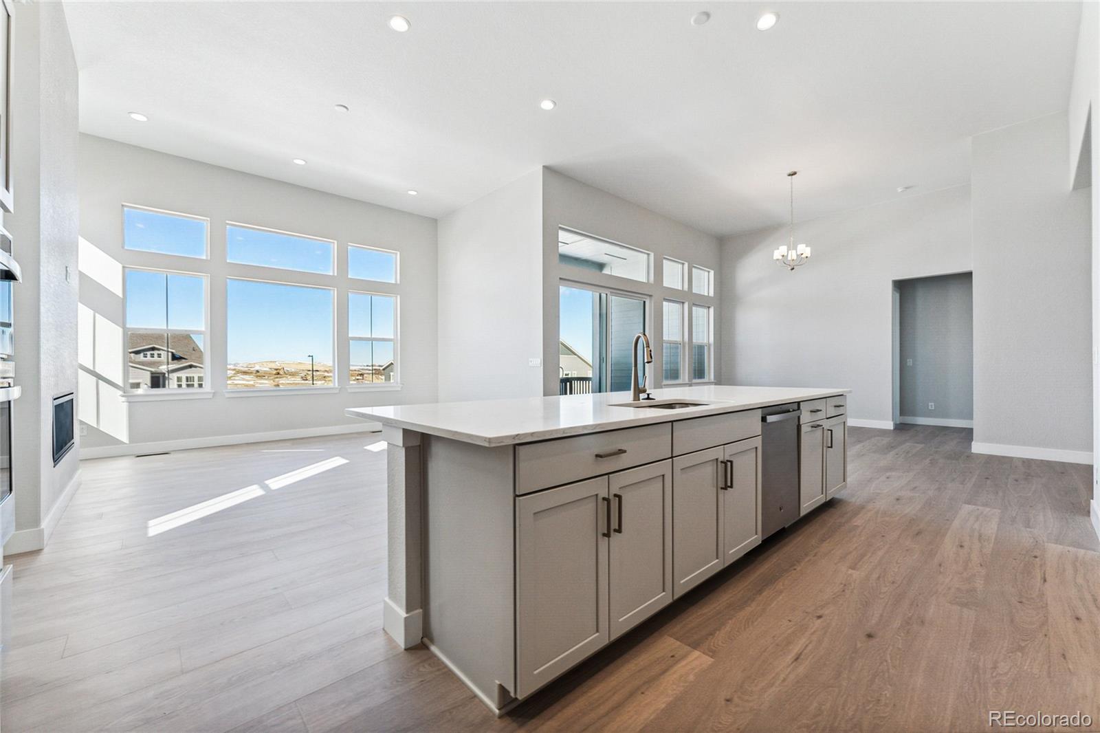 3877 Freestone Point Castle Rock, CO 80108 - Photo 12 of 48 a large kitchen with a lot of counter space and wooden floor
