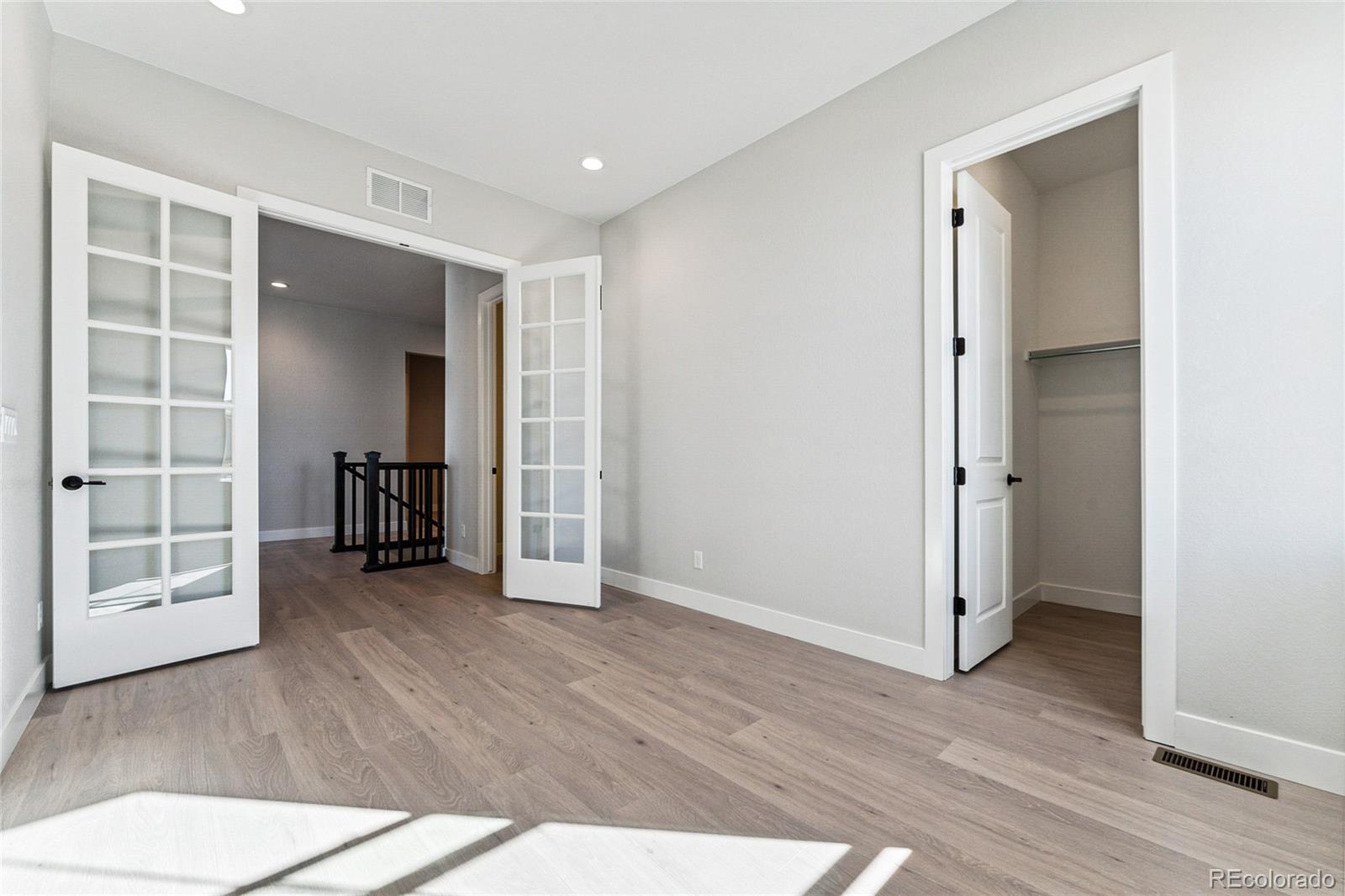 3877 Freestone Point Castle Rock, CO 80108 - Photo 15 of 48 a view of an empty room with wooden floor and a window