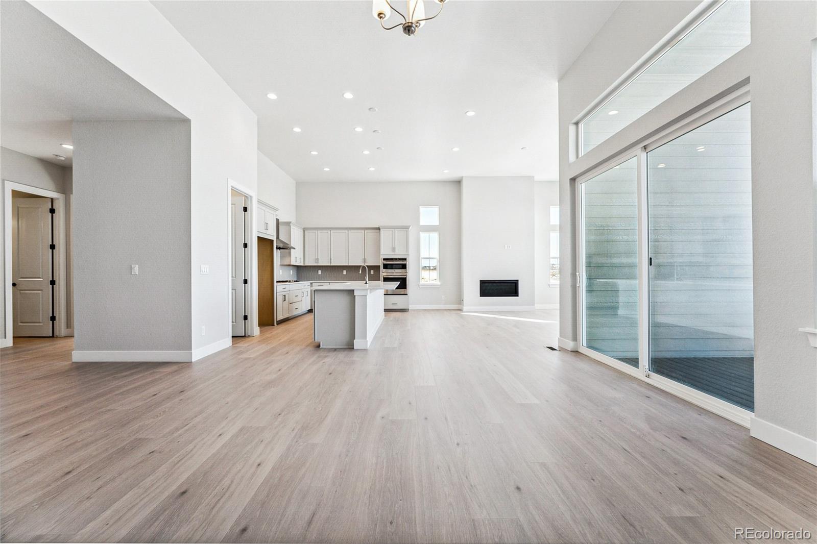 3877 Freestone Point Castle Rock, CO 80108 - Photo 2 of 48 a view of kitchen with stainless steel appliances refrigerator wooden floor and window