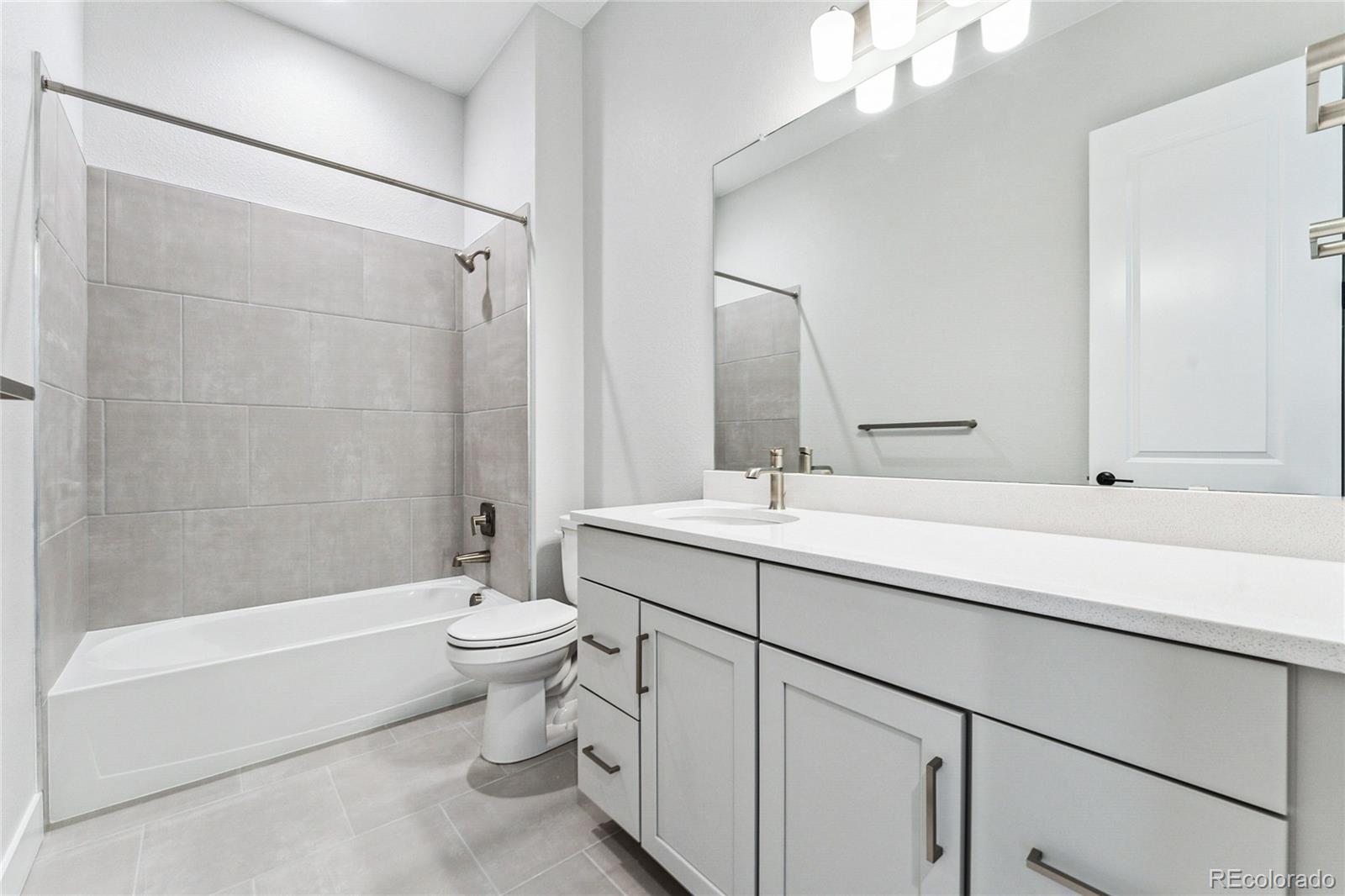 3877 Freestone Point Castle Rock, CO 80108 - Photo 24 of 48 a bathroom with a sink a toilet and shower
