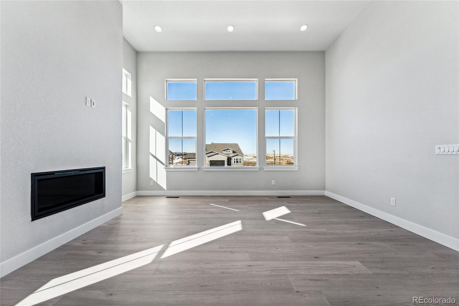 3877 Freestone Point Castle Rock, CO 80108 - Photo 8 of 48 a view of an empty room with a window and kitchen view