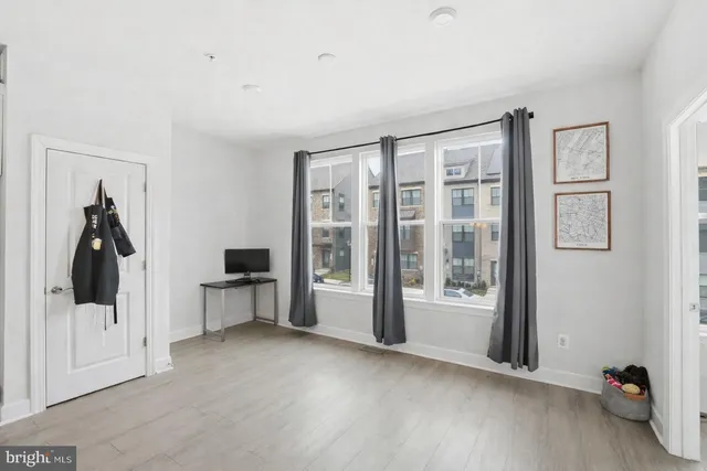 a view of a room with window and hardwood floor