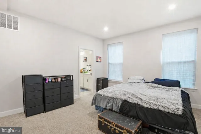 a bedroom with a bed and dresser