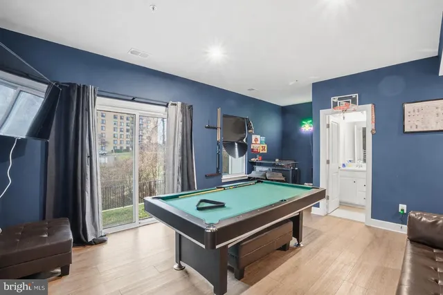 a room with pool table and a flat screen tv