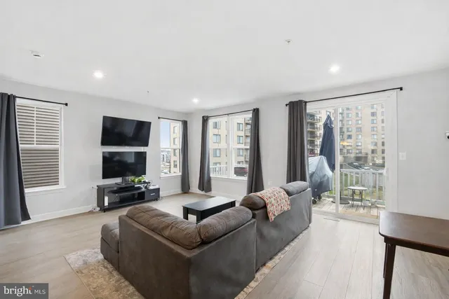 a living room with furniture window and a flat screen tv