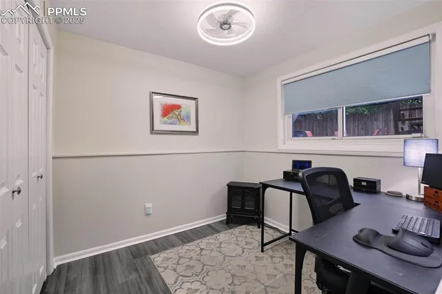 a view of a workspace with furniture and a window