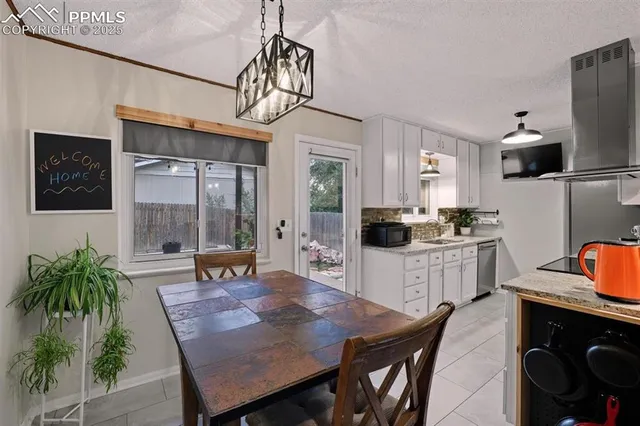 a kitchen with stainless steel appliances granite countertop a stove refrigerator and microwave