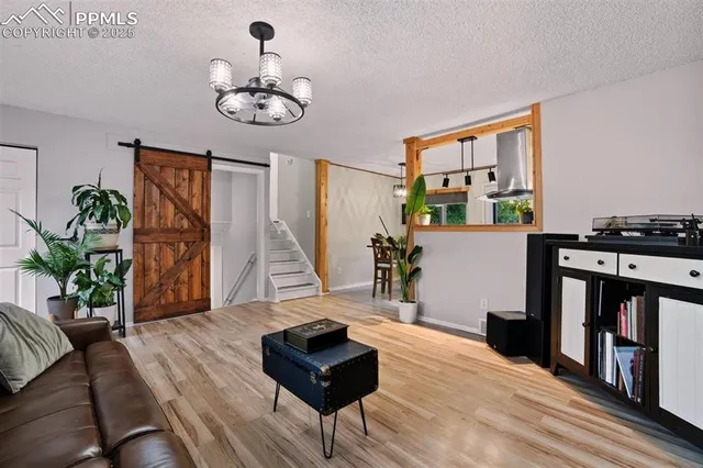 a living room with furniture and a chandelier