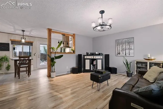 a living room with furniture and wooden floor