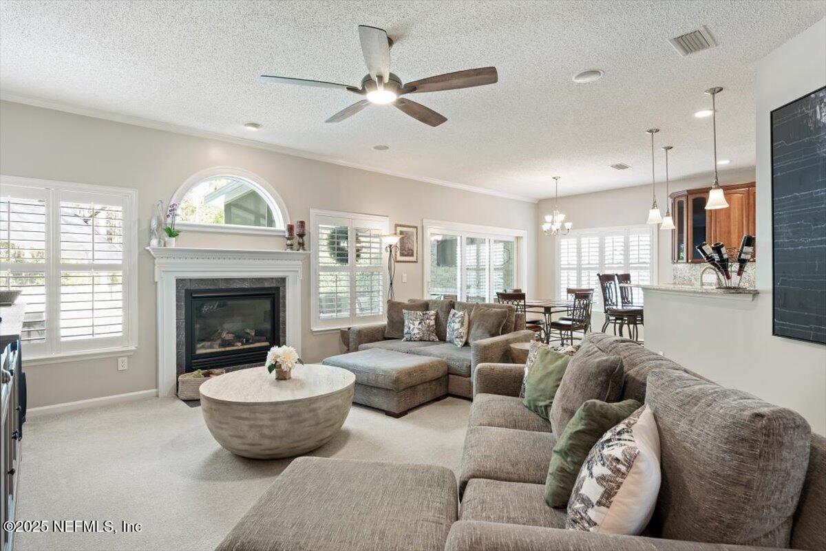 252 Crooked Court St. Johns, FL 32259 - Photo 11 of 72 a living room with furniture a fireplace and a large window