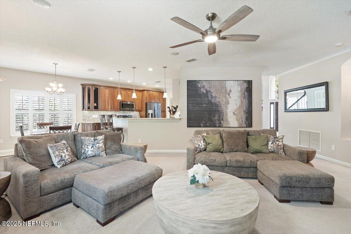 252 Crooked Court St. Johns, FL 32259 - Photo 12 of 72 a living room with furniture kitchen view and a chandelier