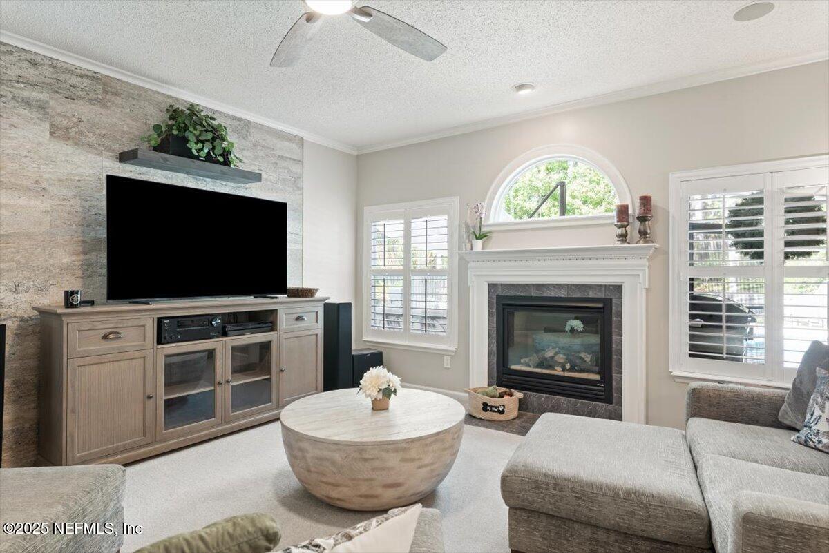 252 Crooked Court St. Johns, FL 32259 - Photo 14 of 72 a living room with furniture a flat screen tv and a fireplace