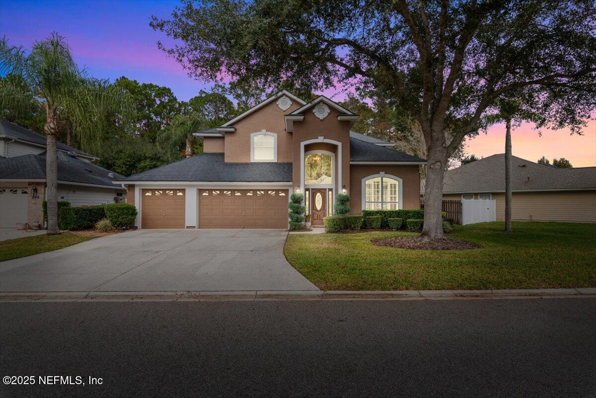 252 Crooked Court St. Johns, FL 32259 - Photo 2 of 72 a front view of a house with a garden and tree