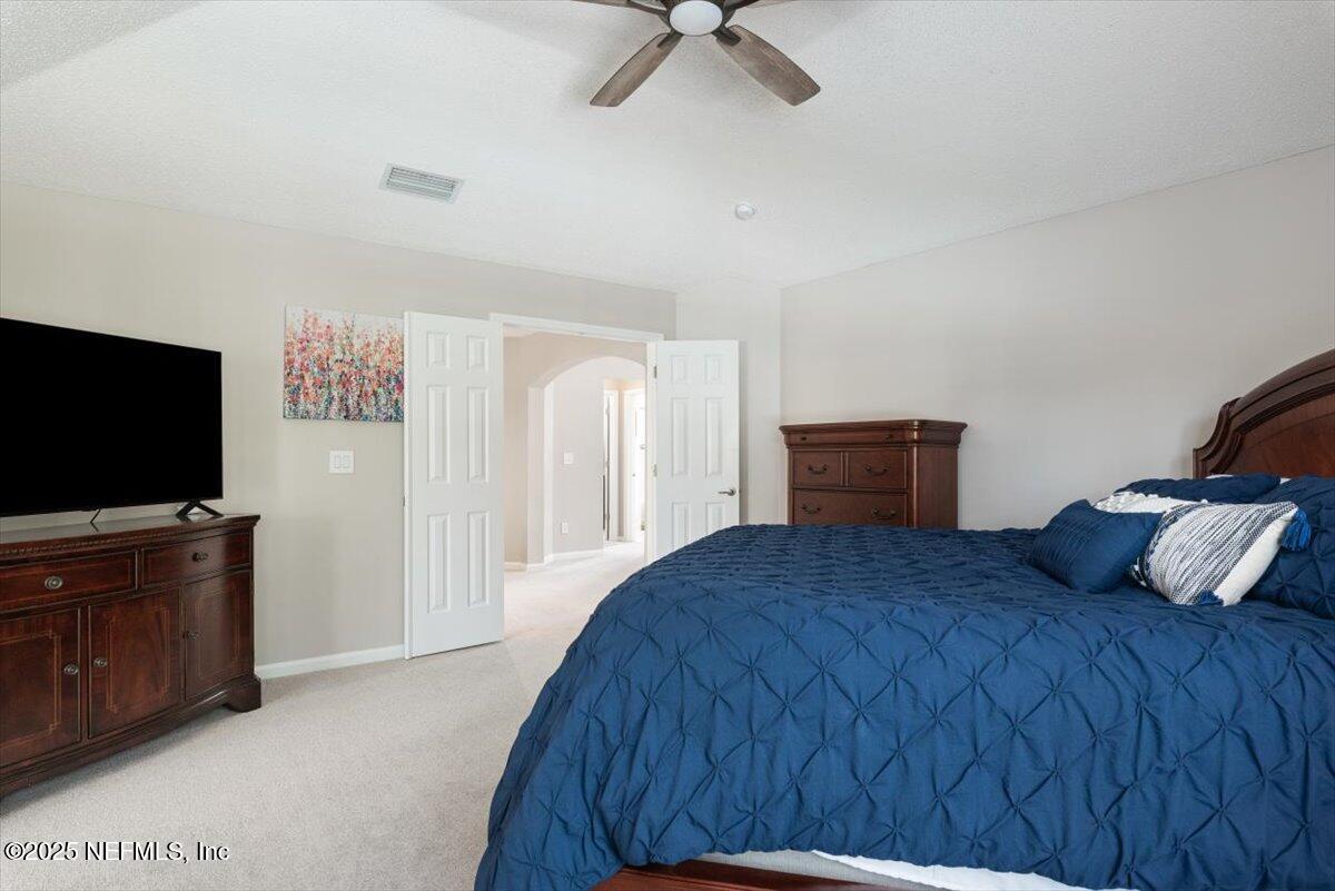 252 Crooked Court St. Johns, FL 32259 - Photo 25 of 72 a bedroom with a bed and a flat screen television