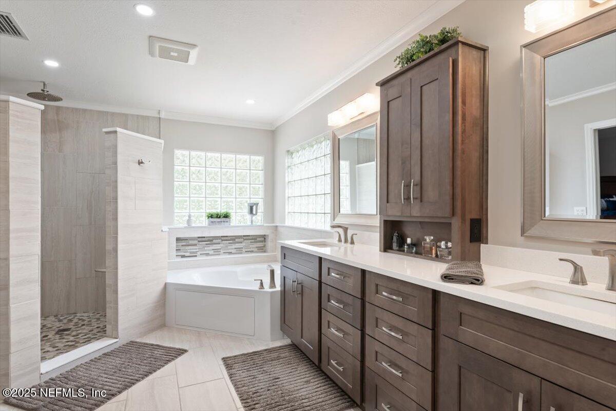 252 Crooked Court St. Johns, FL 32259 - Photo 26 of 72 a bathroom with a double vanity sink a mirror and a bathtub