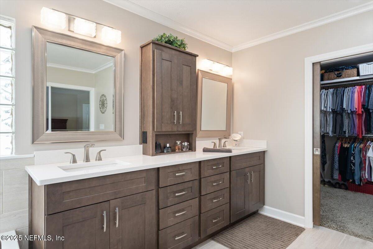 252 Crooked Court St. Johns, FL 32259 - Photo 29 of 72 a bathroom with a double vanity sink and a mirror
