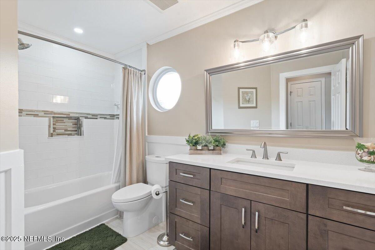 252 Crooked Court St. Johns, FL 32259 - Photo 32 of 72 a bathroom with a granite countertop sink toilet a large mirror a bathtub and shower