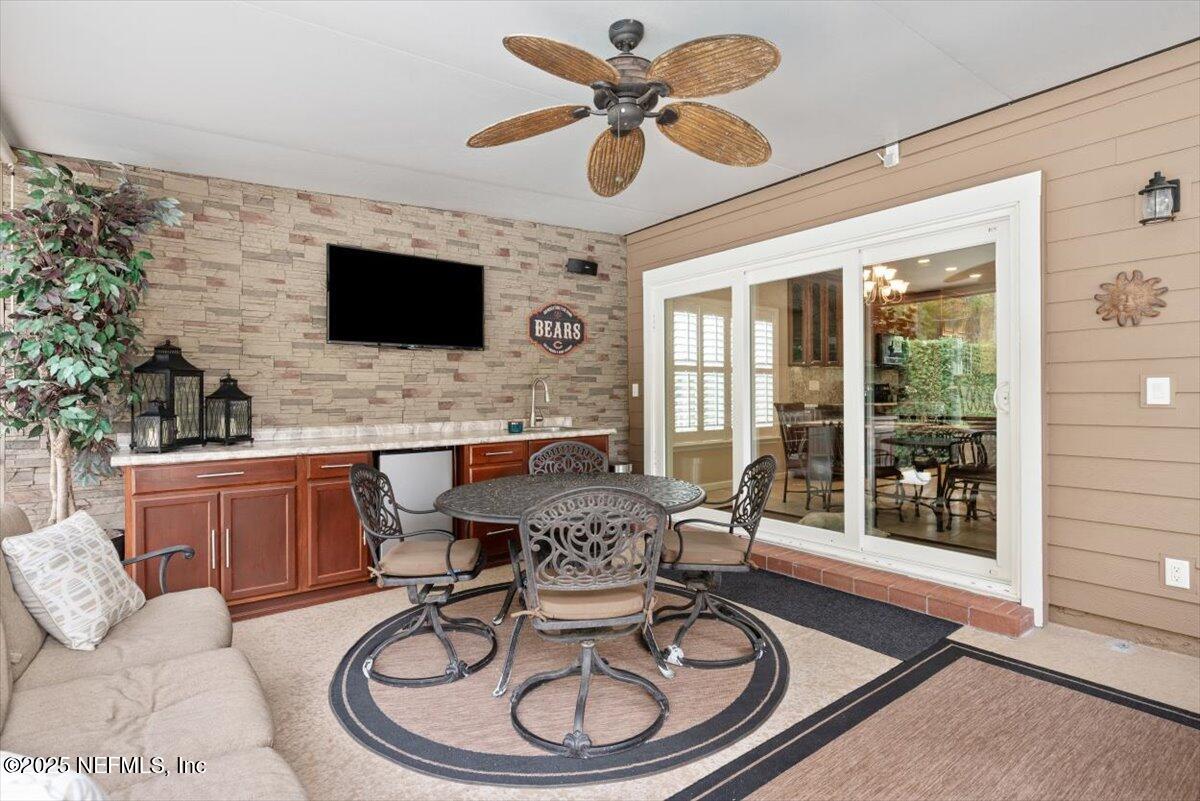 252 Crooked Court St. Johns, FL 32259 - Photo 38 of 72 a living room with furniture a flat screen tv and a large window