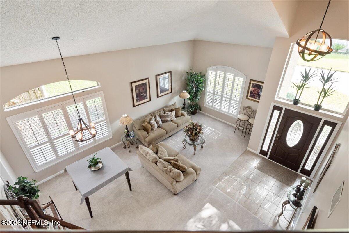 252 Crooked Court St. Johns, FL 32259 - Photo 5 of 72 a view of living room with furniture and a chandelier