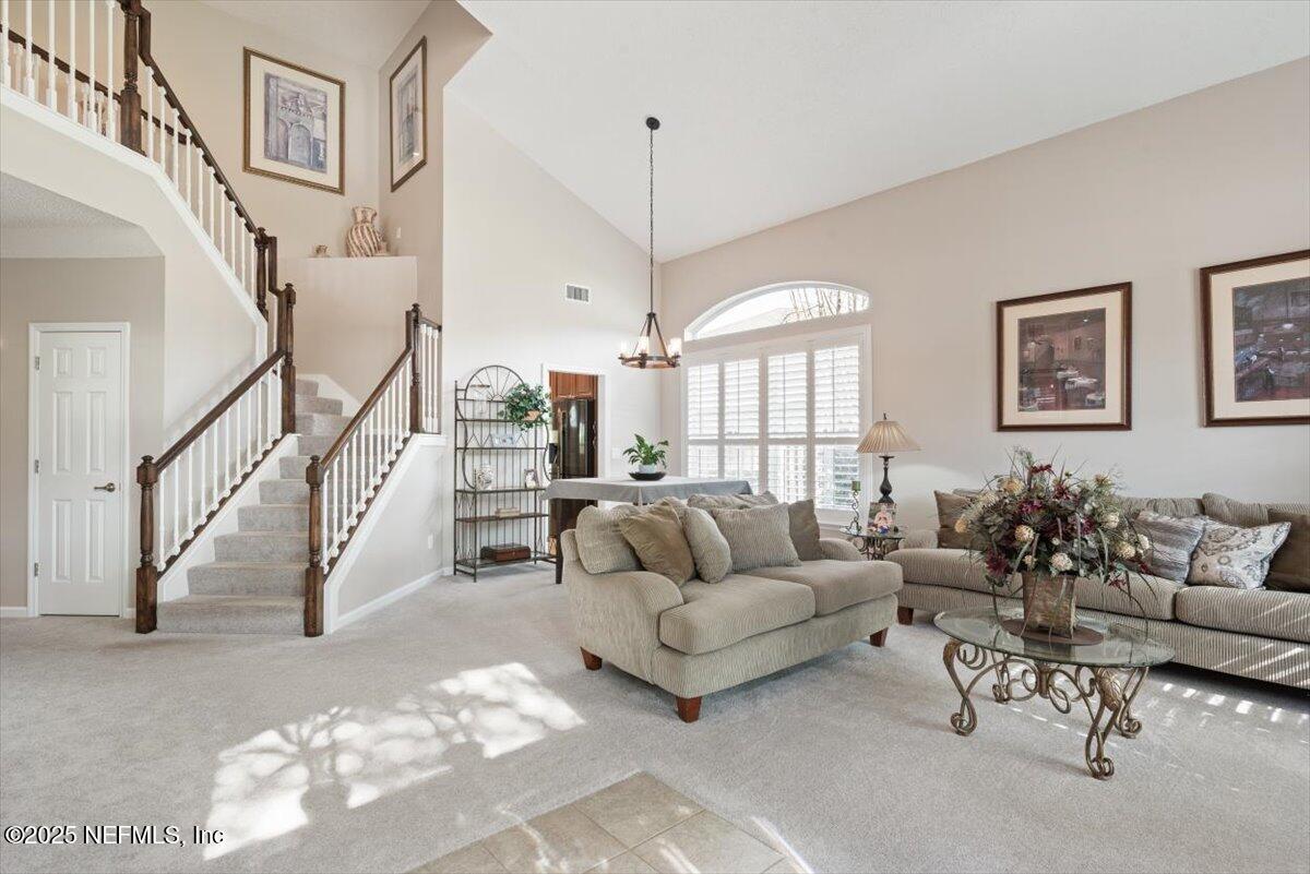 252 Crooked Court St. Johns, FL 32259 - Photo 7 of 72 a living room with furniture and a chandelier