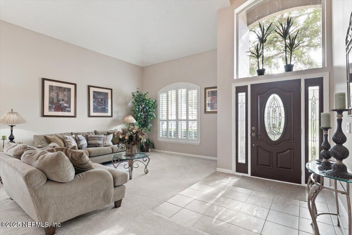 252 Crooked Court St. Johns, FL 32259 - Photo 8 of 72 a living room with furniture a chandelier and a window