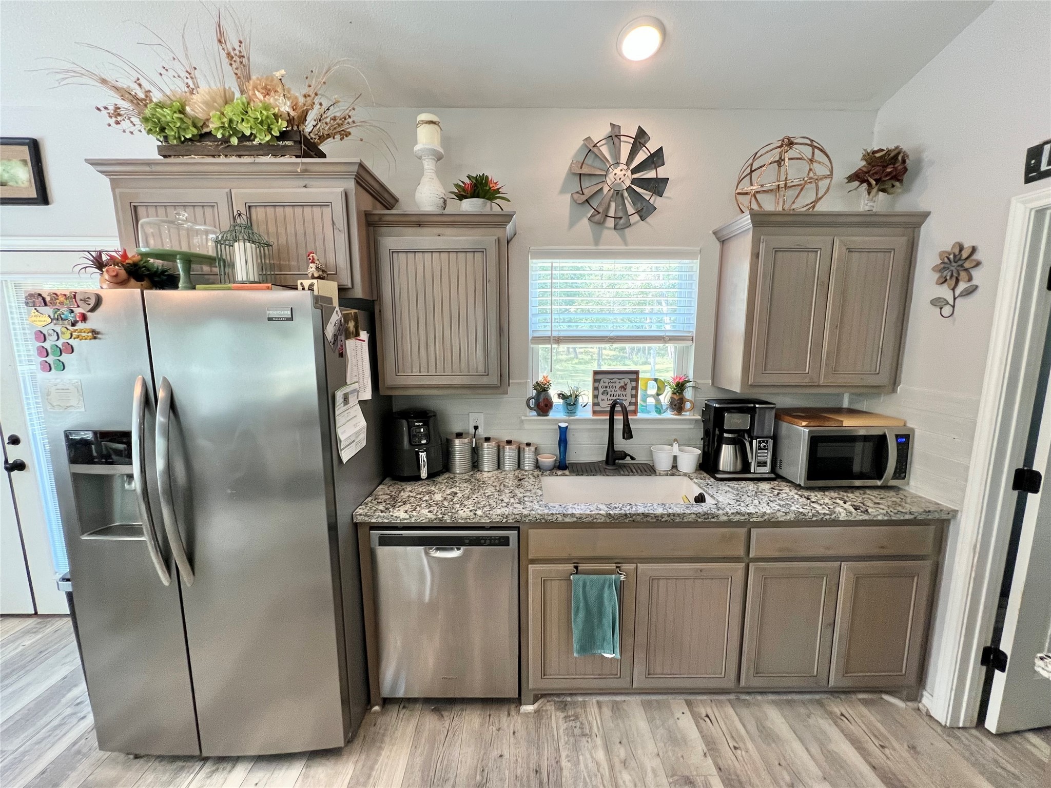 22740 Brazos Circle Damon, TX 77430 - Photo 11 of 30 a kitchen with stainless steel appliances granite countertop a refrigerator a sink a stove a dining table and chairs