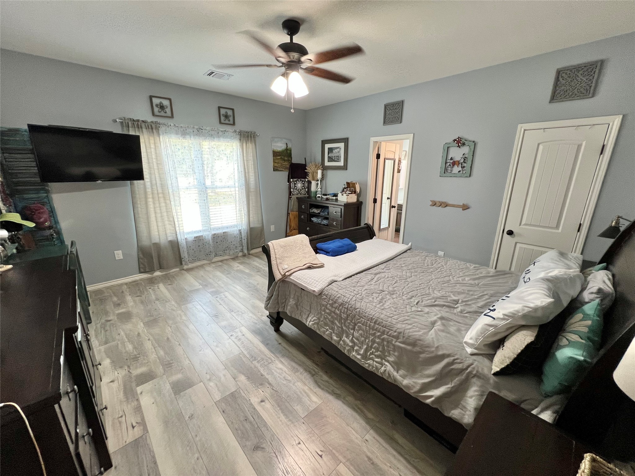 22740 Brazos Circle Damon, TX 77430 - Photo 25 of 30 a bedroom with a bed window and a flat screen tv