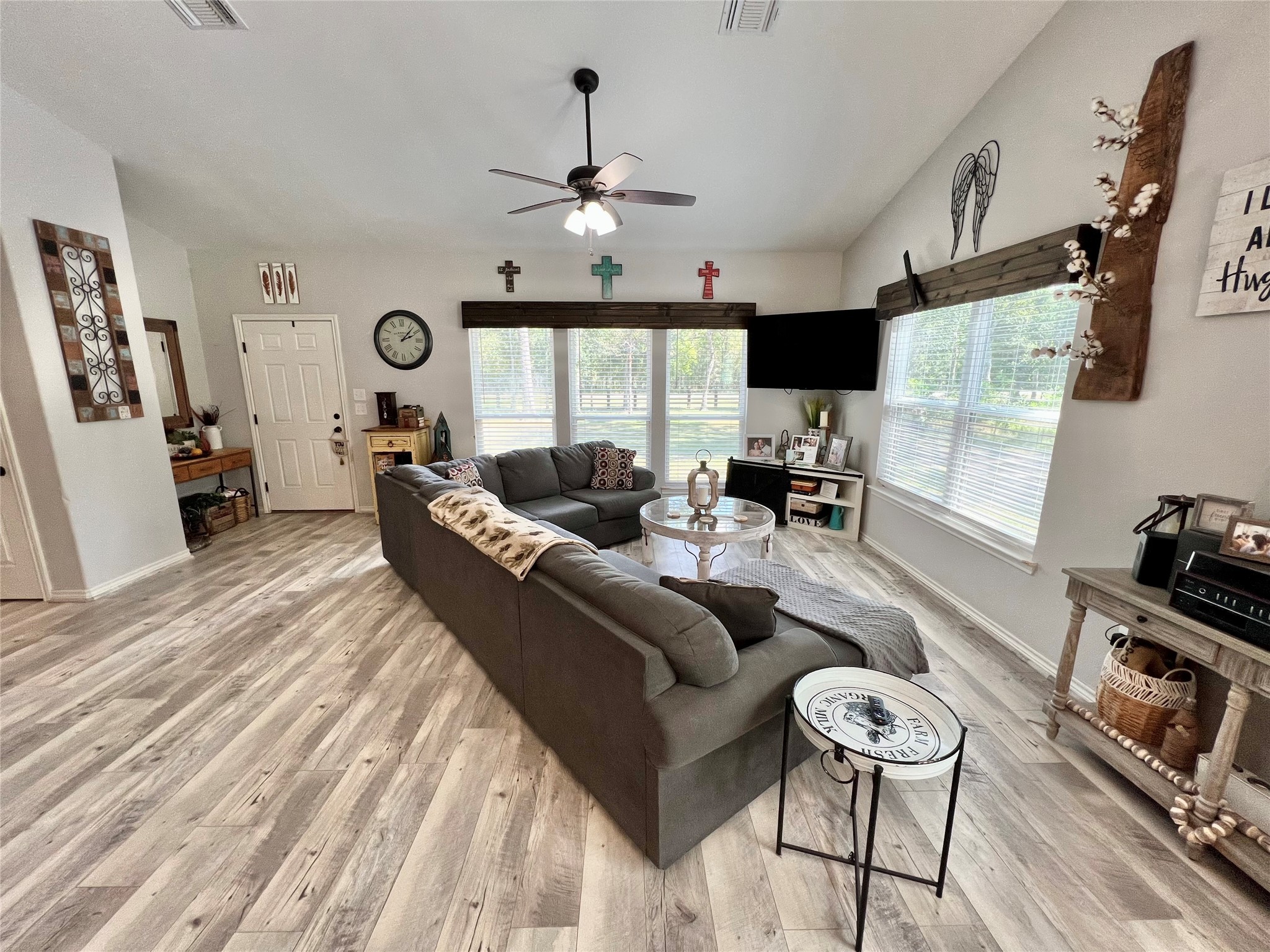 22740 Brazos Circle Damon, TX 77430 - Photo 4 of 30 a living room with furniture a flat screen tv and a large window