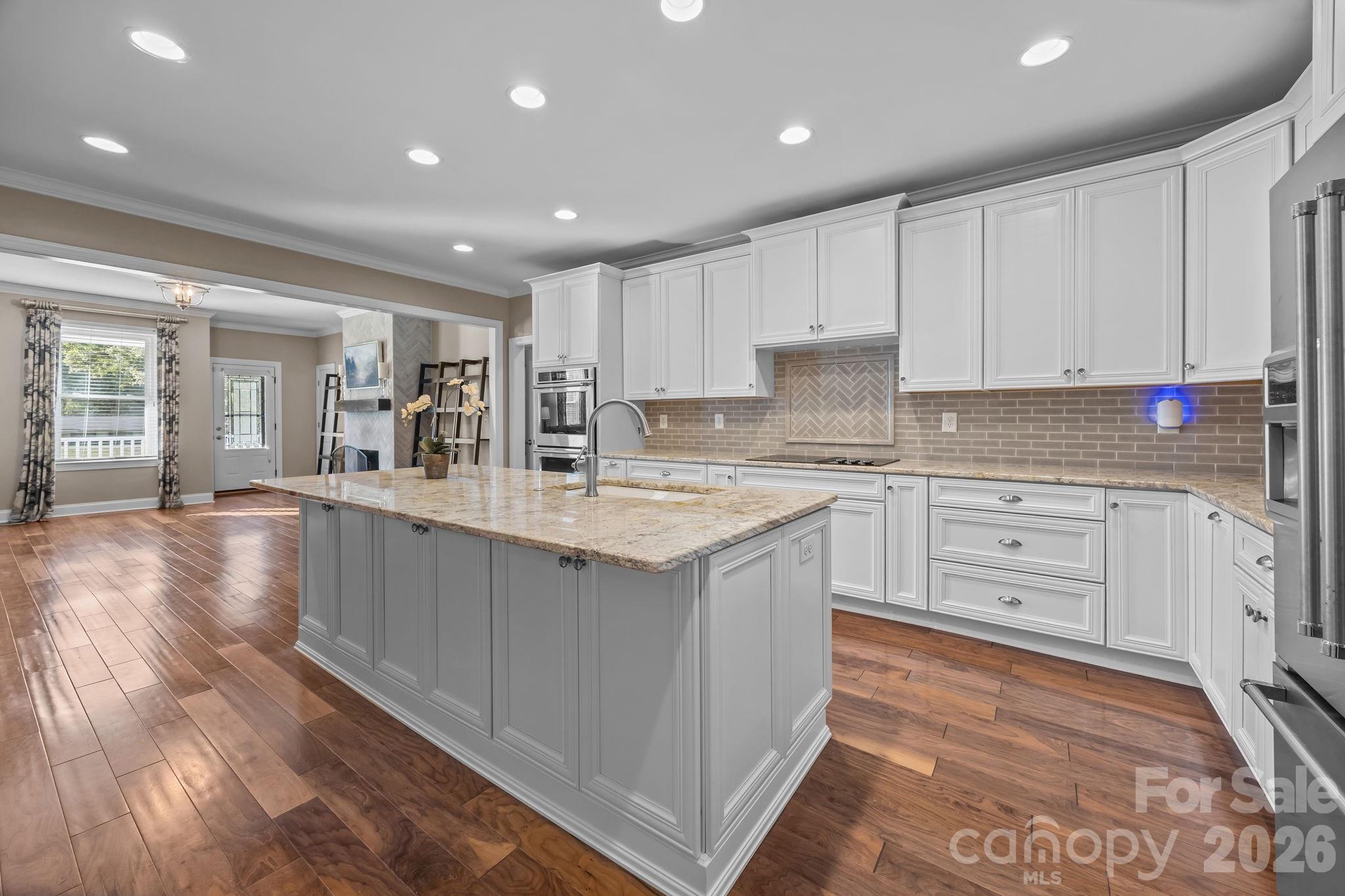 1614 Old Nation Road Fort Mill, SC 29715 - Photo 3 of 47 a kitchen with granite countertop white cabinets and white stainless steel appliances