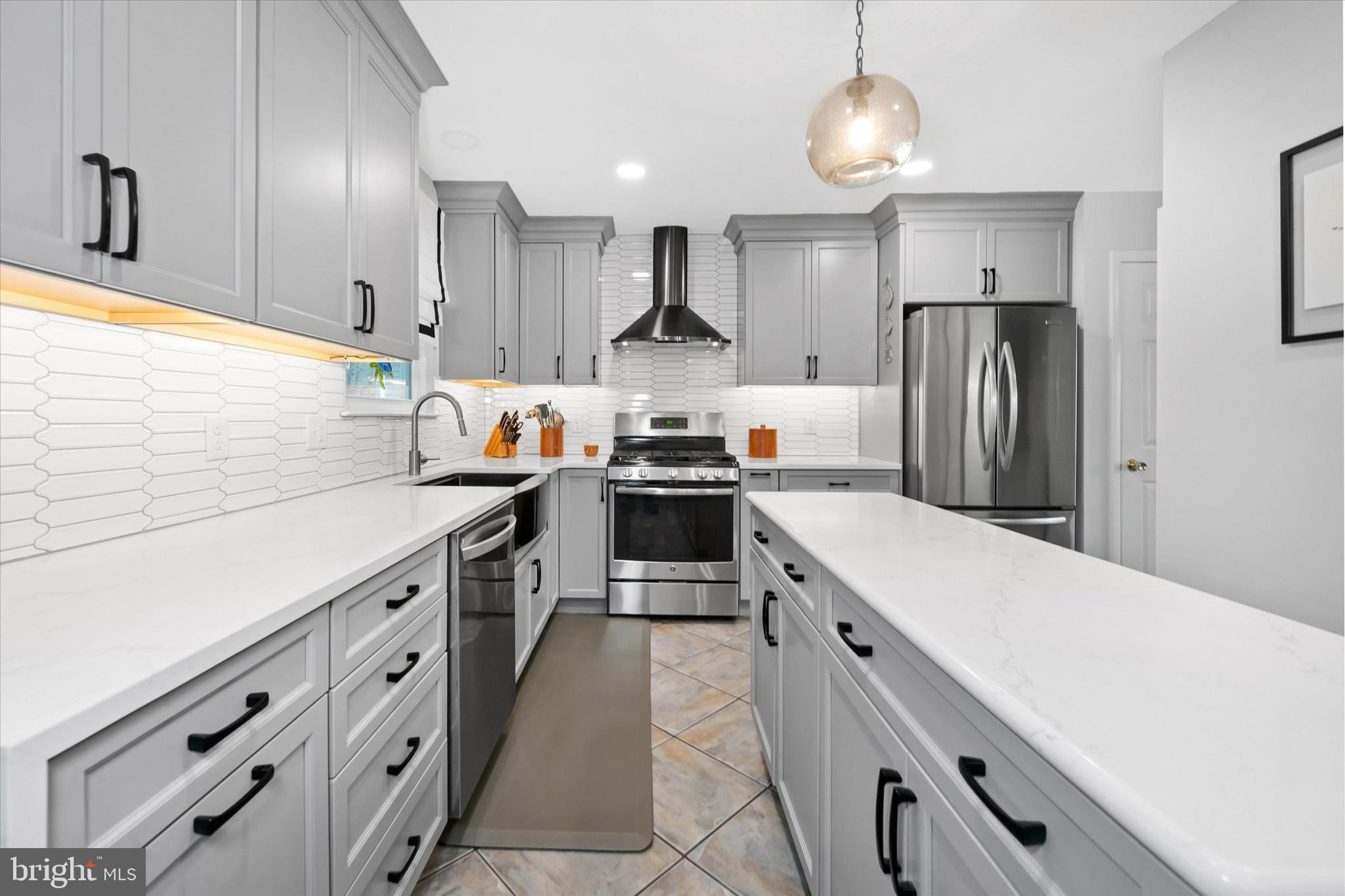 710 Fox Chase Circle Bear, DE 19701 - Photo 13 of 55 a kitchen with white cabinets and stainless steel appliances