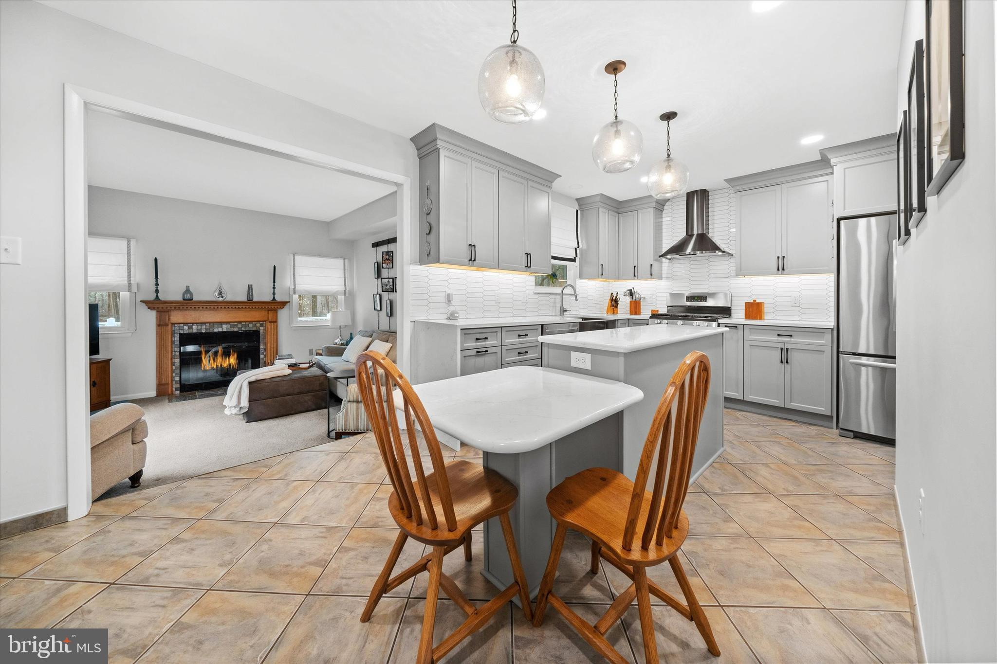 710 Fox Chase Circle Bear, DE 19701 - Photo 16 of 55 a kitchen with kitchen island a stove a chandelier a dining table and chairs