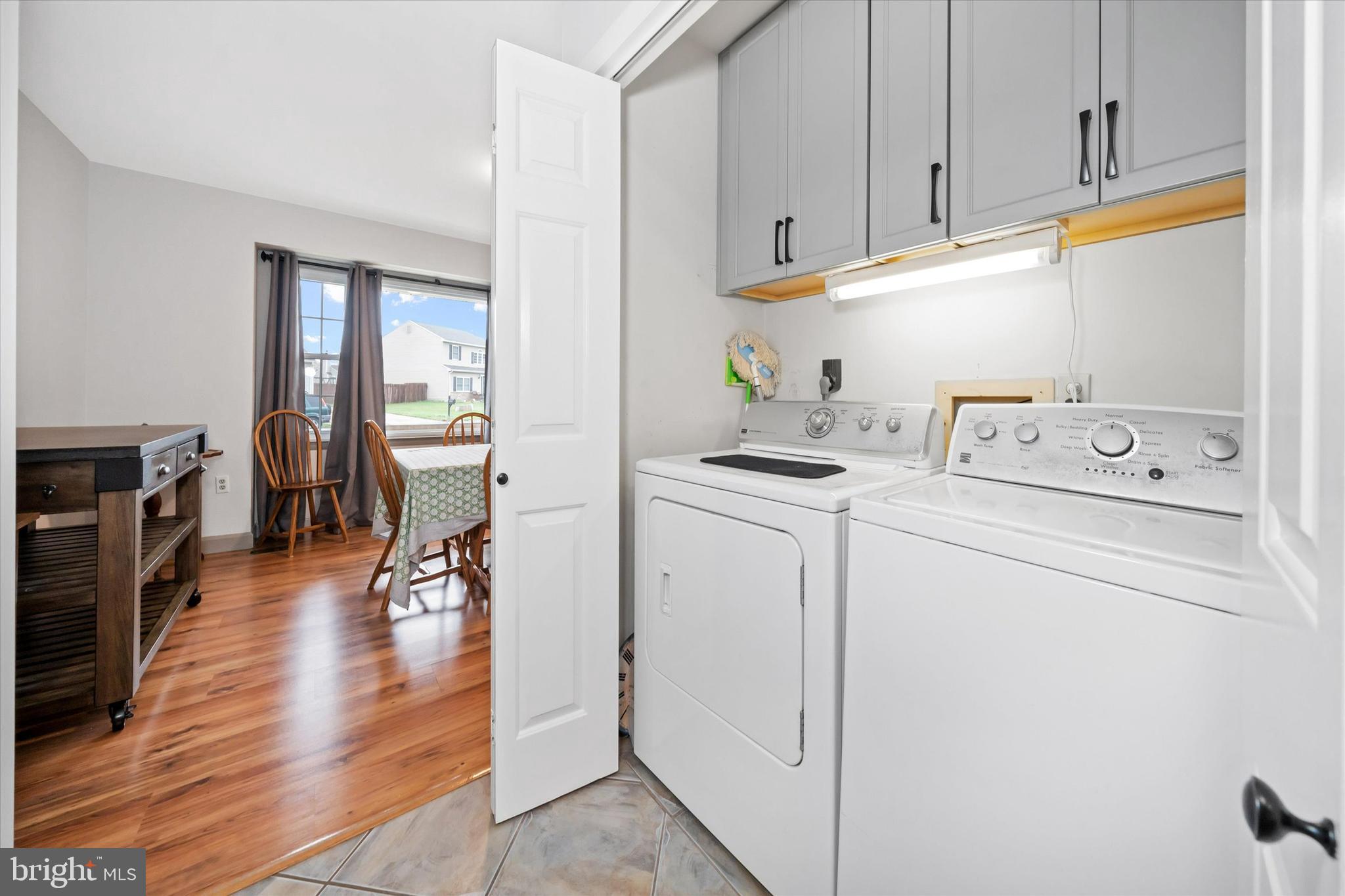 710 Fox Chase Circle Bear, DE 19701 - Photo 20 of 55 a view of washer and dryer with kitchen in the background