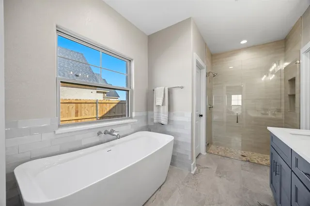 a bathroom with a bathtub and a sink