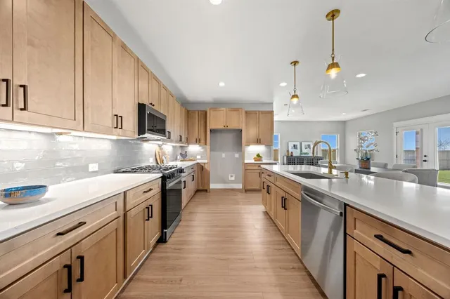 a kitchen with granite countertop cabinets stainless steel appliances and a sink