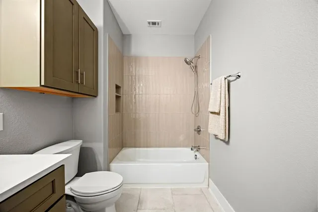 a bathroom with a toilet a sink and bathtub