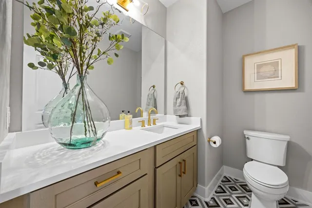 a bathroom with a toilet a sink and mirror