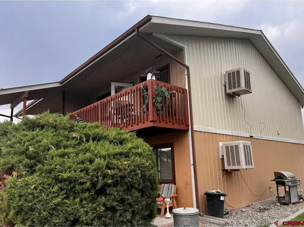 a view of a small house with roof deck