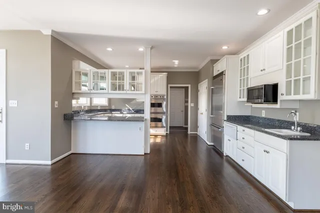 a spacious bedroom with a bed and a flat screen tv
