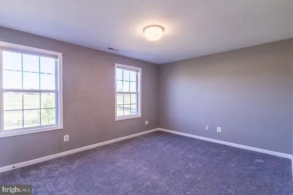 a view of hallway with wooden floor