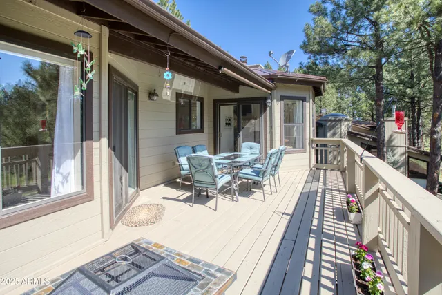 a view of a patio with couches table and chairs and potted plants