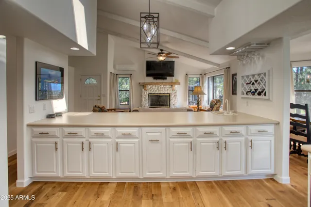 a kitchen with stainless steel appliances granite countertop a sink and a white cabinets