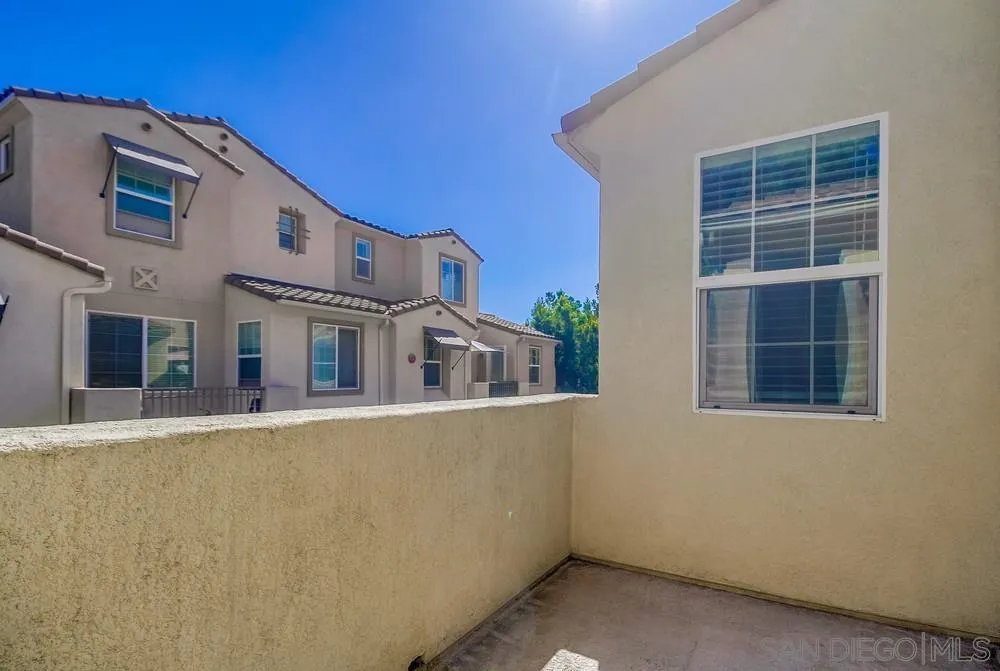 1298 Fools Gold Way, Unit 4 Chula Vista, CA 91913 - Photo 31 of 38 a front view of a house with a yard